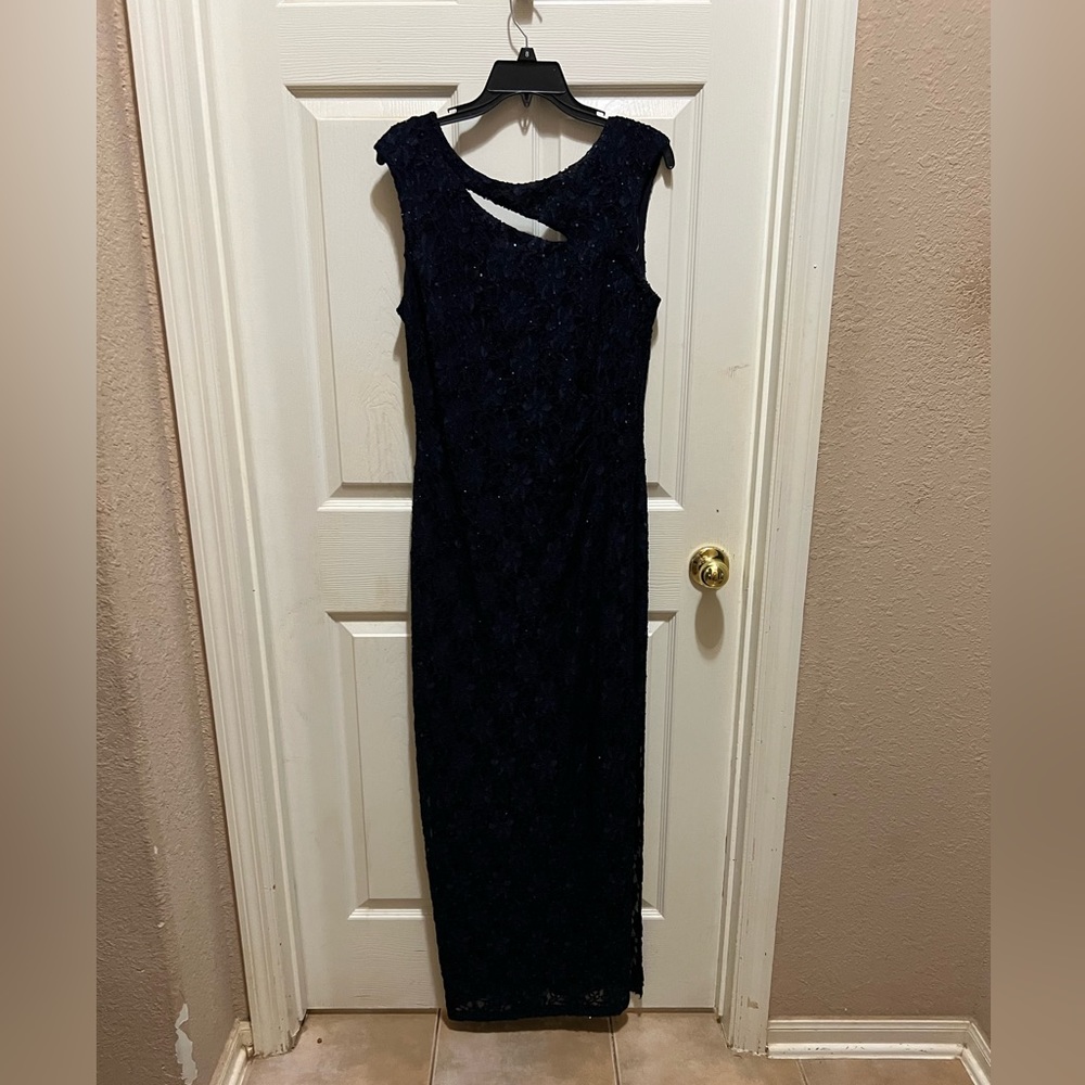 Long formal navy blue sleeveless dress has long speed thin cover up with it